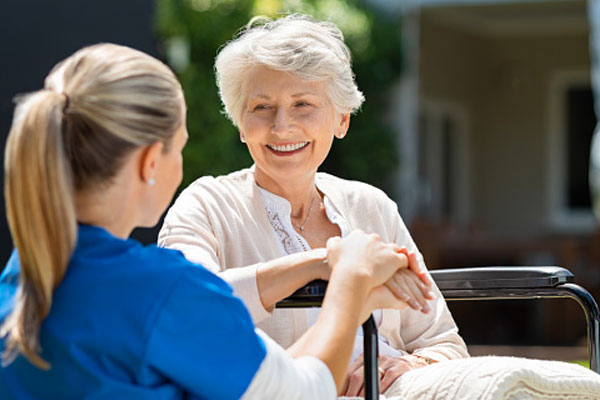 eldery woman in wheelchair with female nurse