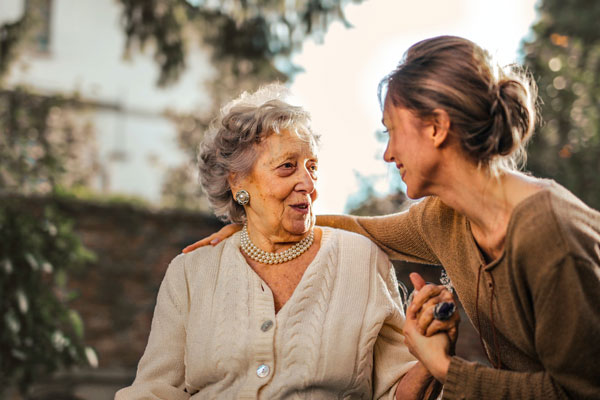 Eldery woman with care giver outdoors